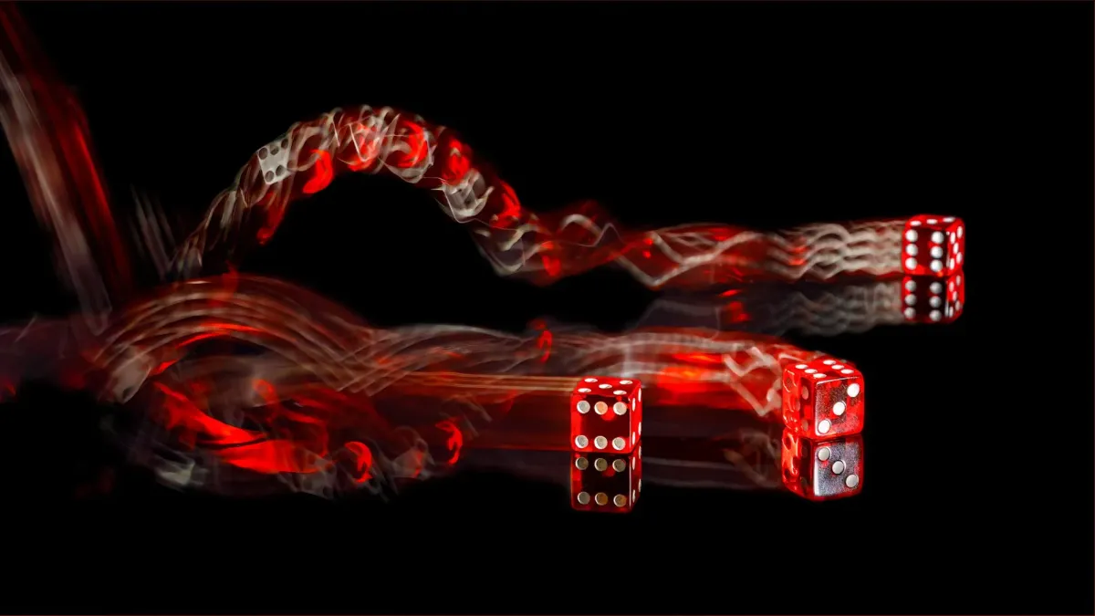 Three red dice bouncing with red light trails on black